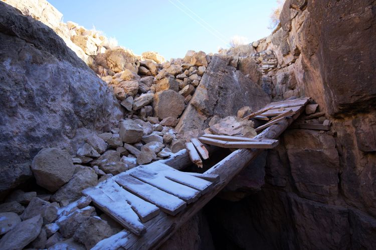 A damaged wooden bridge crossing a rocky gap in a canyon, representing the need for wisdom, care, and responsibility when deciding how to use what is true.