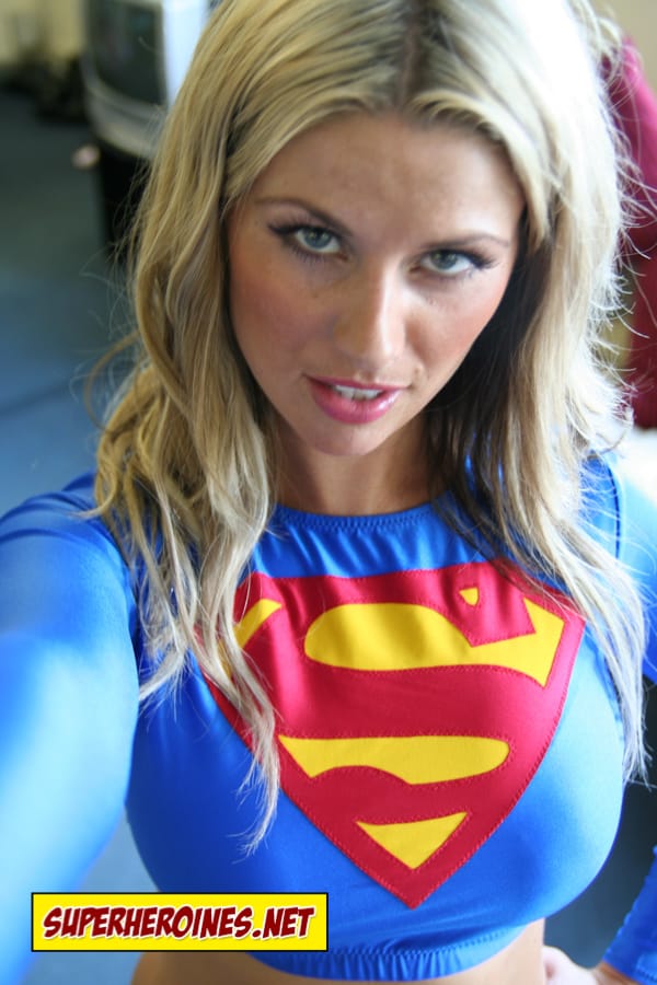 Pretty blonde Supergirl lifting man up by his collar