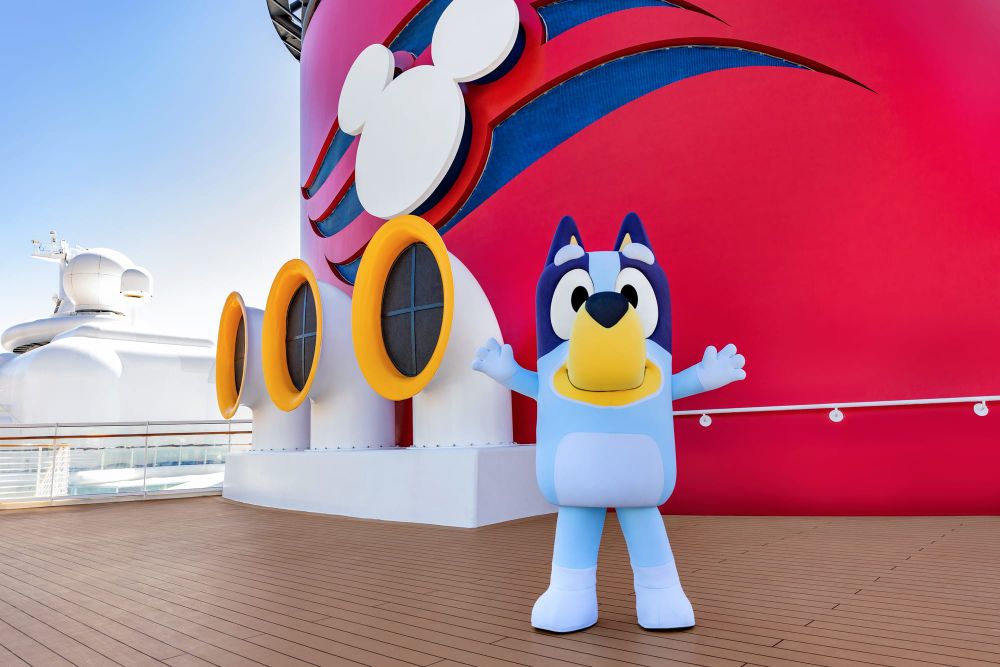 Bluey waving on the deck of a Disney Cruise Line ship