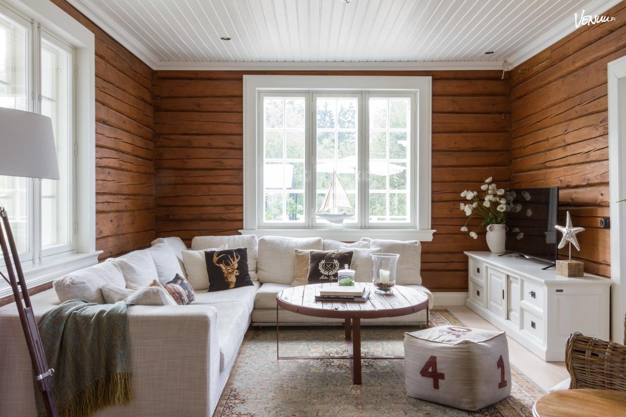 Villa Stengbergin olohuone, upeat hirsiseinät ja vaalea sisustus - Venuu.fi