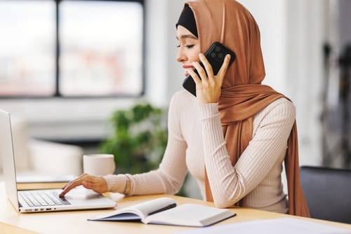 Women with a headscarf speaking on the phone