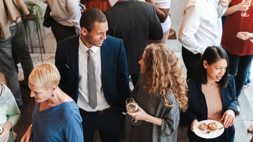 People socializing in a business networking event