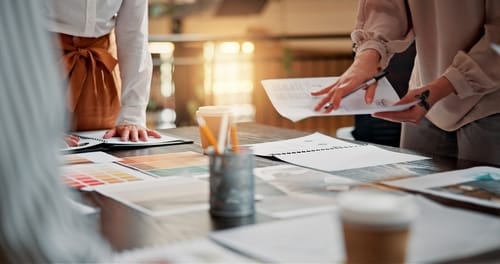 Real estate agents reviewing branding materials and marketing assets for luxury property listings