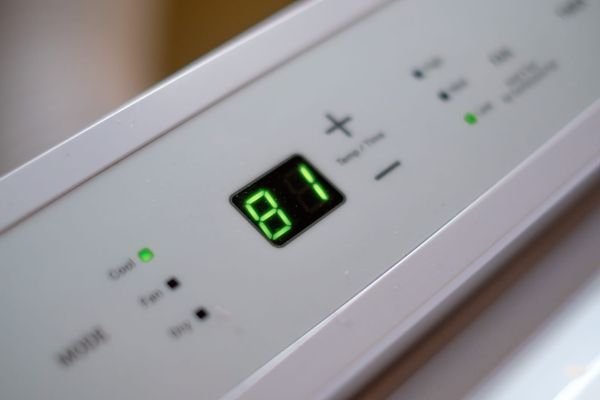 Thermostat on an air conditioner reads 81 degrees Fahrenheit.