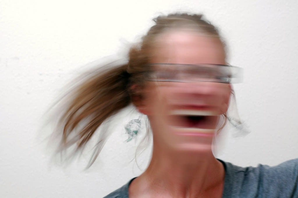 A woman screaming. Image is blurry.