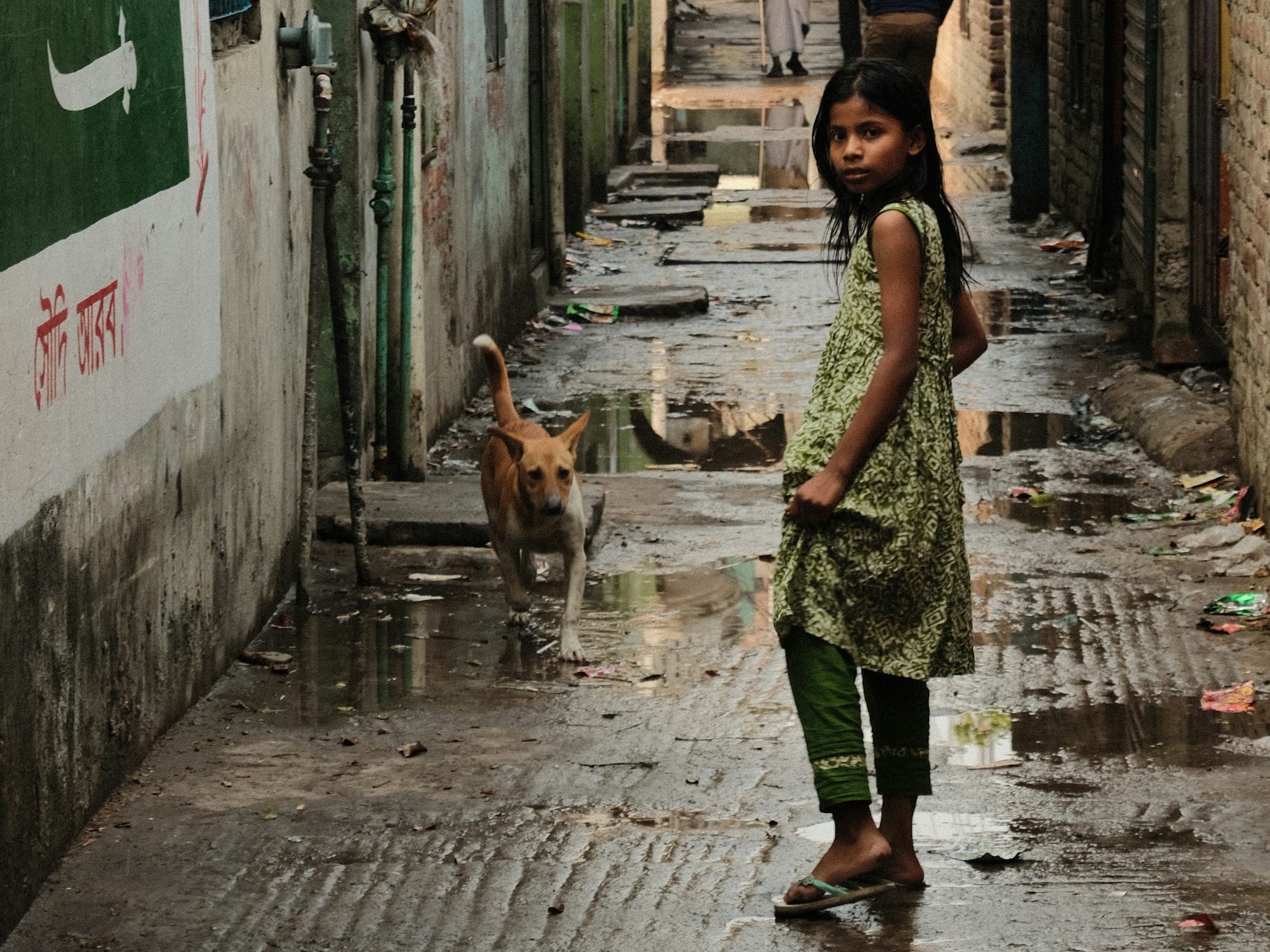 a little girl that is standing in the rain