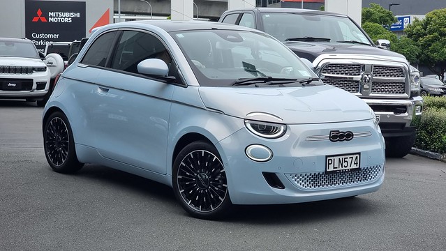 Fiat 500e (full electric) in front of a truck that will mostly transport the same amount of people and stuff...