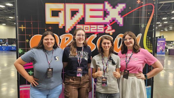 Shawnee State University gaming students & alumni gathered around the GDEX 2025 backdrop.