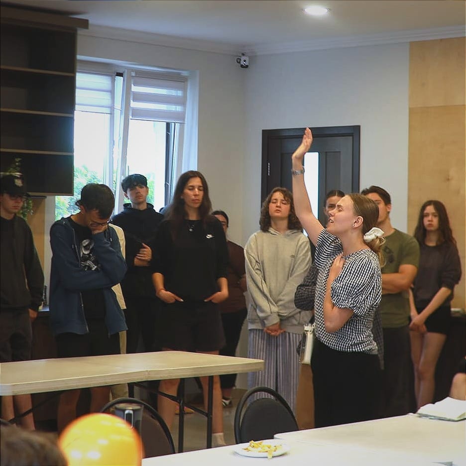 Anhelina and YWAM students worshipping before training