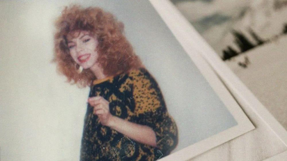 Polaroid photograph of Venus Xtravaganza with big '80s curly hair, woolen sweater and hoop earrings.