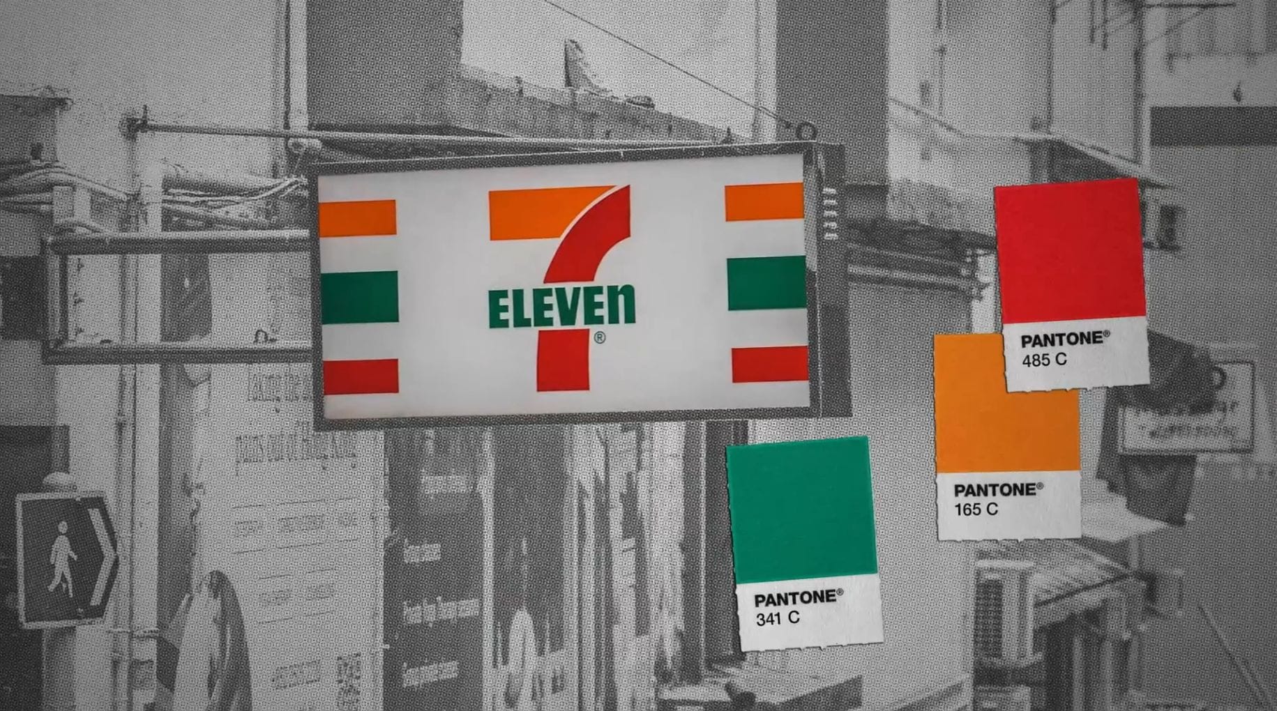 A 7 Eleven sign with graphics showing us Pantone 341C, Pantone 165C and Pantone 485C on chips alongside.