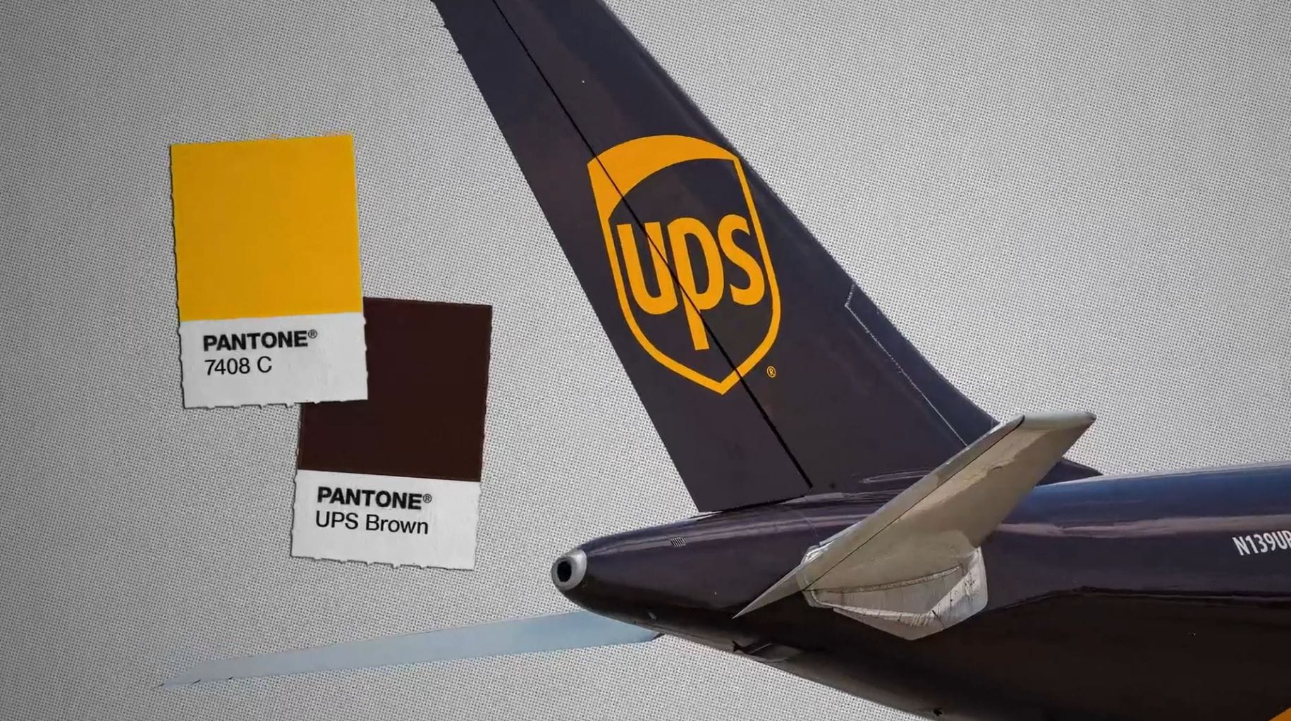 A UPS airplane painted in the colours of dark brown and yellow, as graphics show us Pantone 7408C and Pantone UPS Brown colours on little chips.