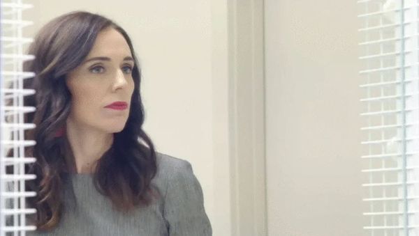 Jacinta Ardern looks out of an office.