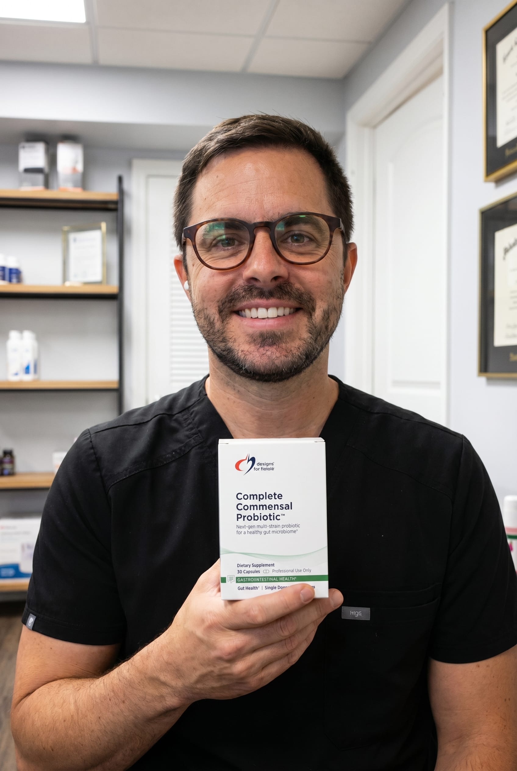 Dr. Bell holding Complete Commensal Probiotic
