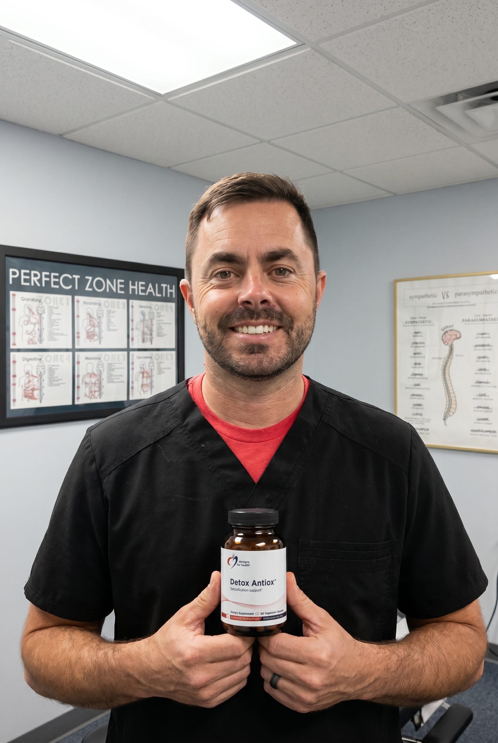 Dr. Bell holding Detox Antiox