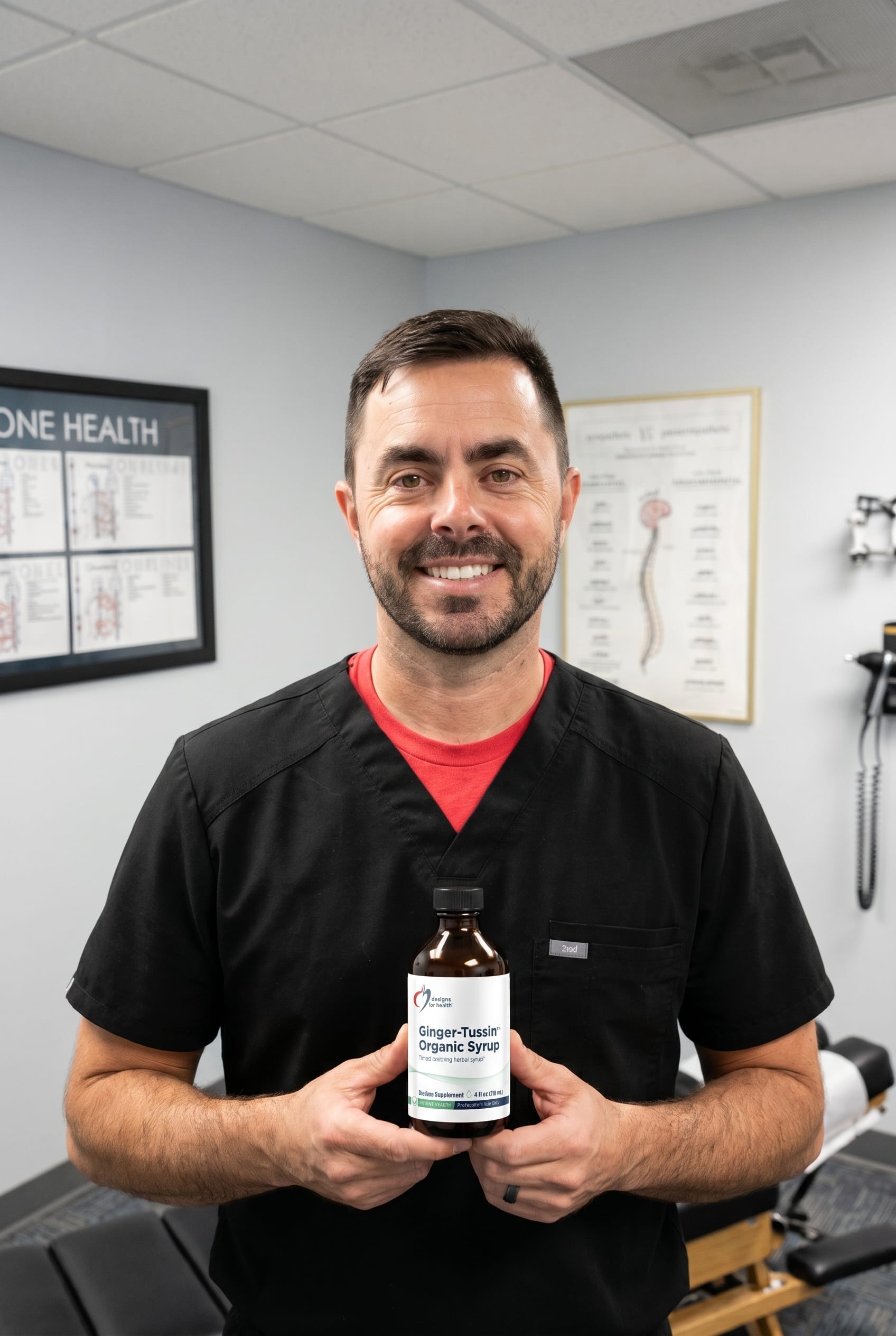 Dr. Bell holding Ginger-Tussin Organic Syrup