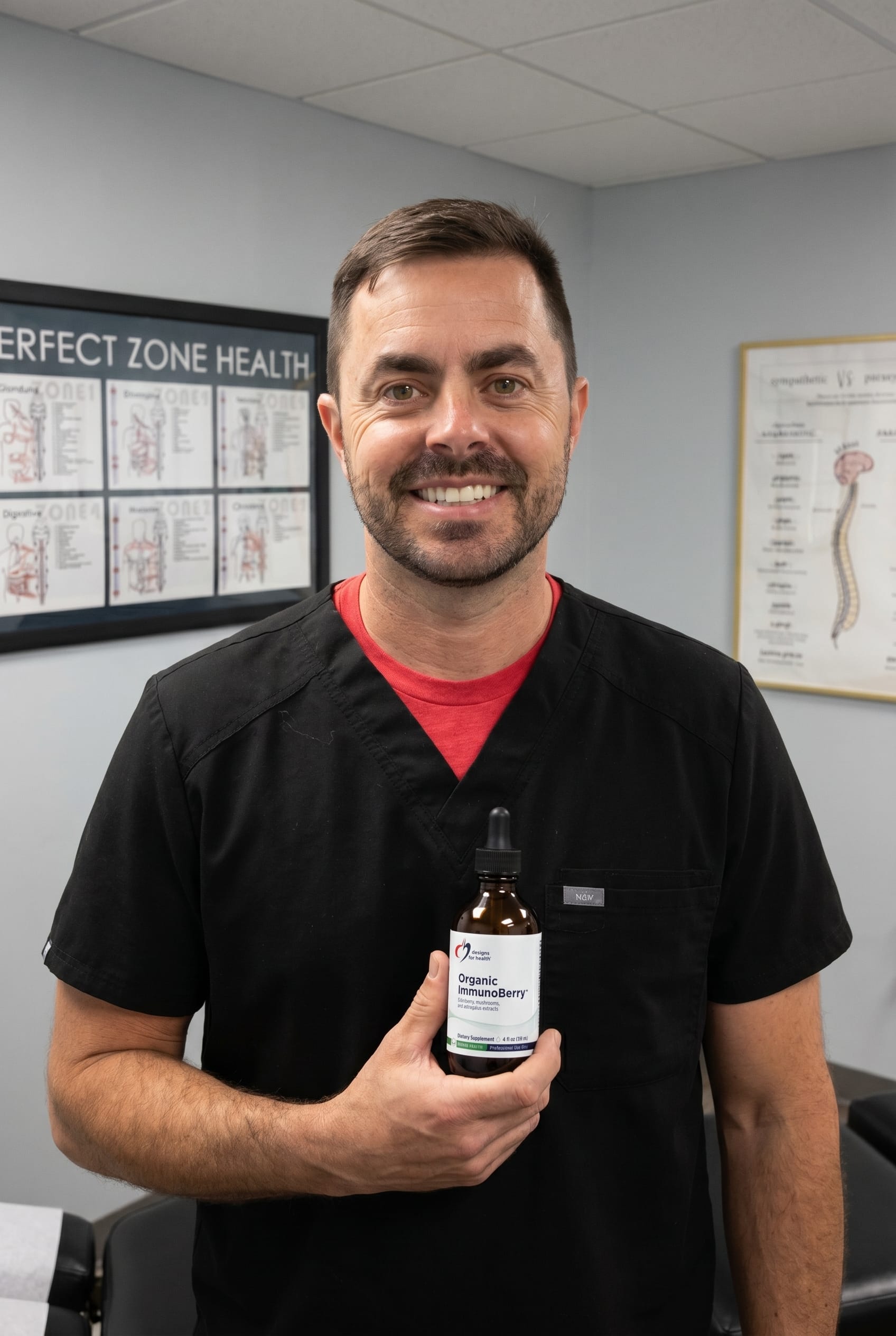 Dr. Bell holding Organic ImmunoBerry Liquid