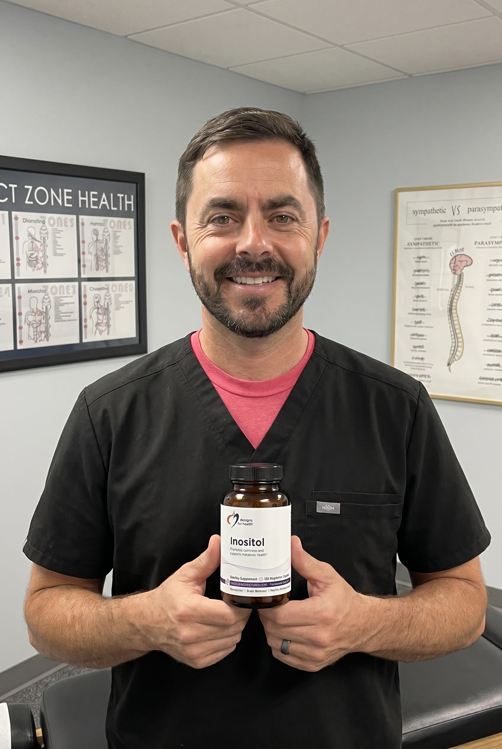 Dr. Bell holding inositol-capsules