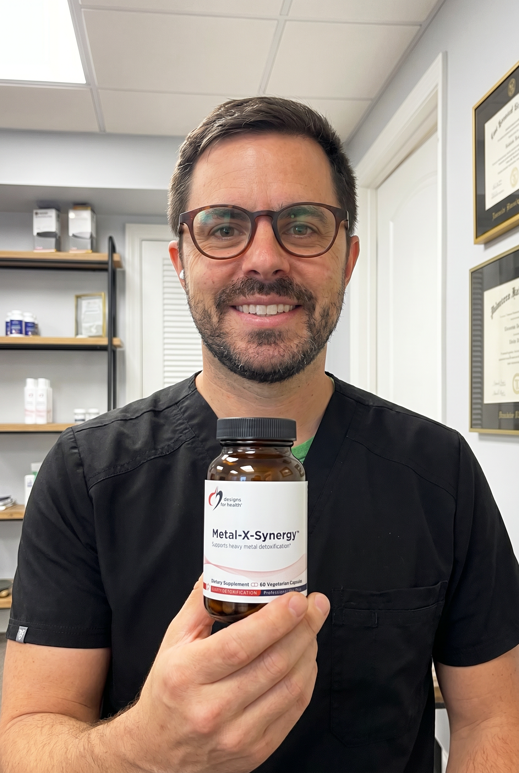 Dr. Bell holding Metal-X-Synergy