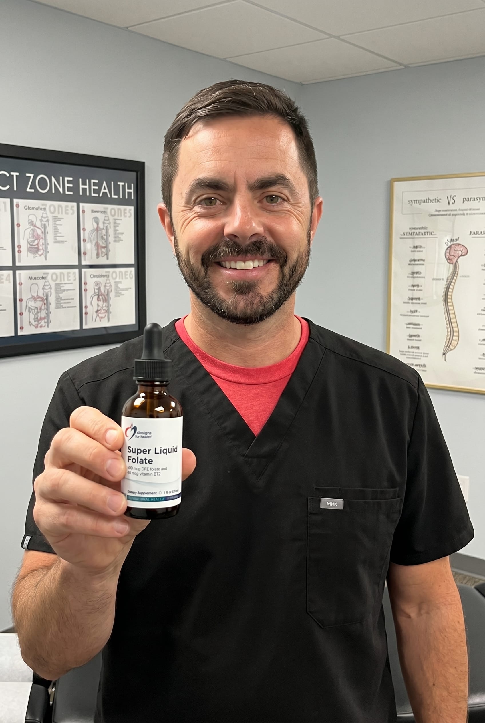 Dr. Bell holding Super Liquid Folate