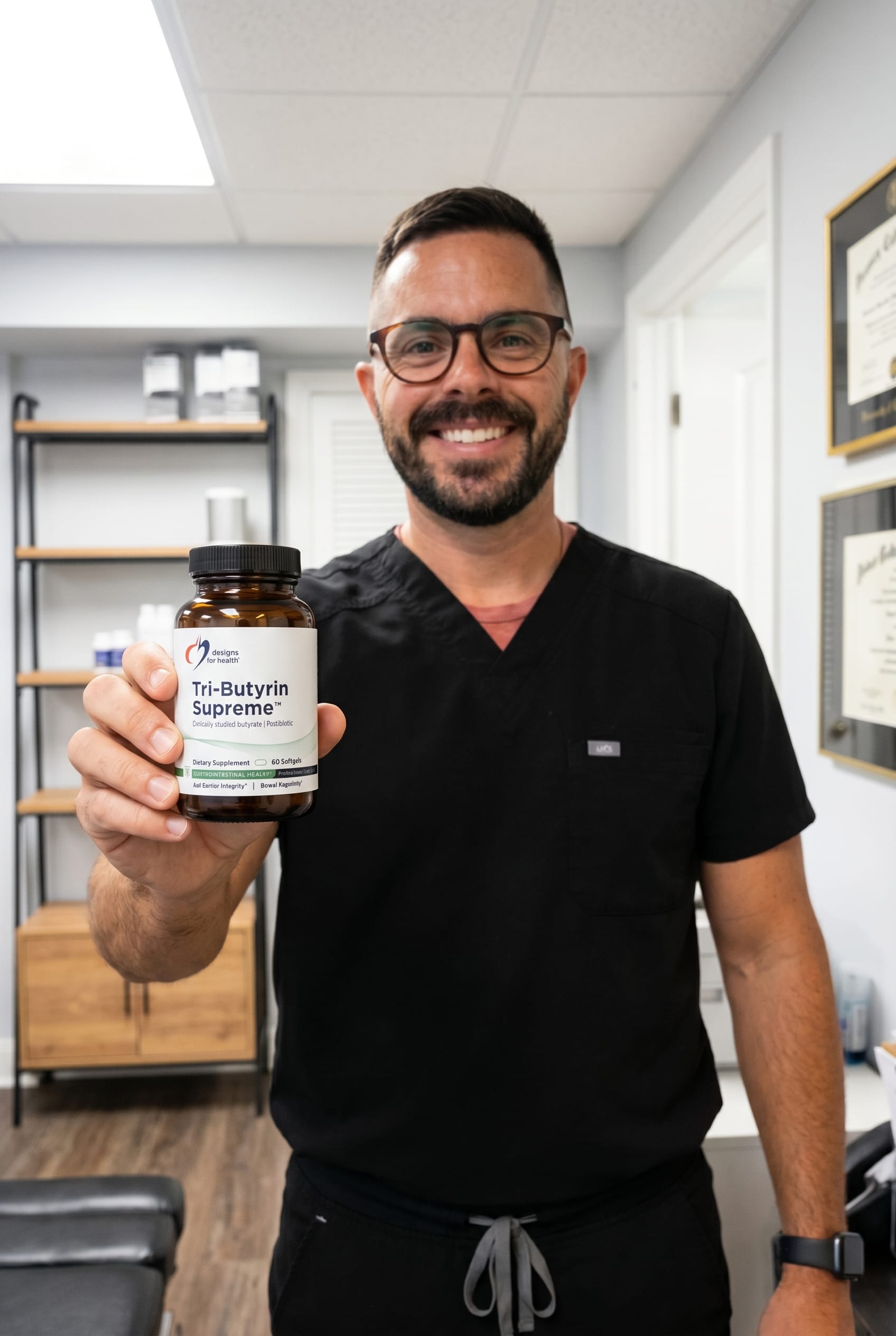 Dr. Bell holding Tri-Butyrin Supreme