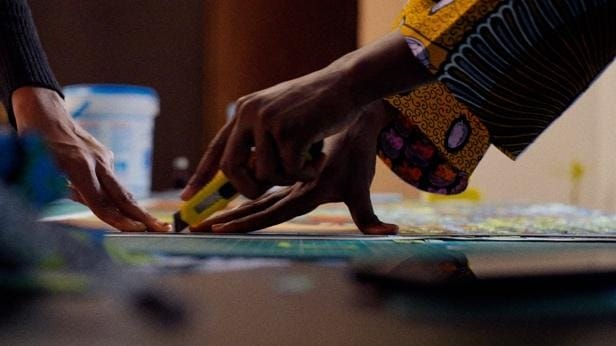 A close-up of a hand cutting a piece of paper
AI-generated content may be incorrect.