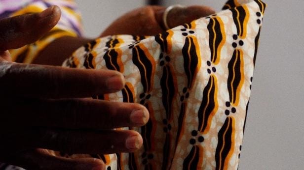 A close-up of a hand holding a fabric
AI-generated content may be incorrect.