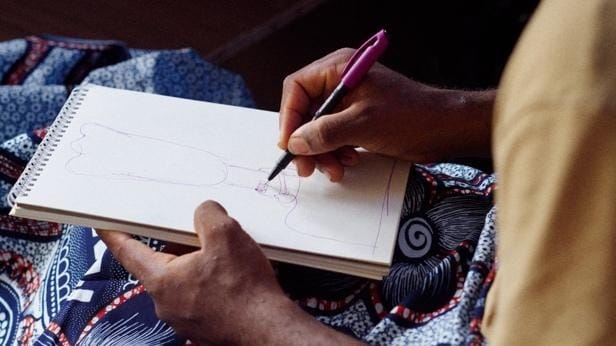 A close-up of a person drawing
AI-generated content may be incorrect.