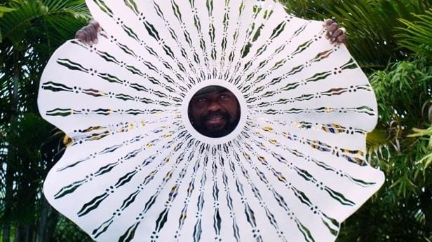 A person's face in a circular white paper
AI-generated content may be incorrect.