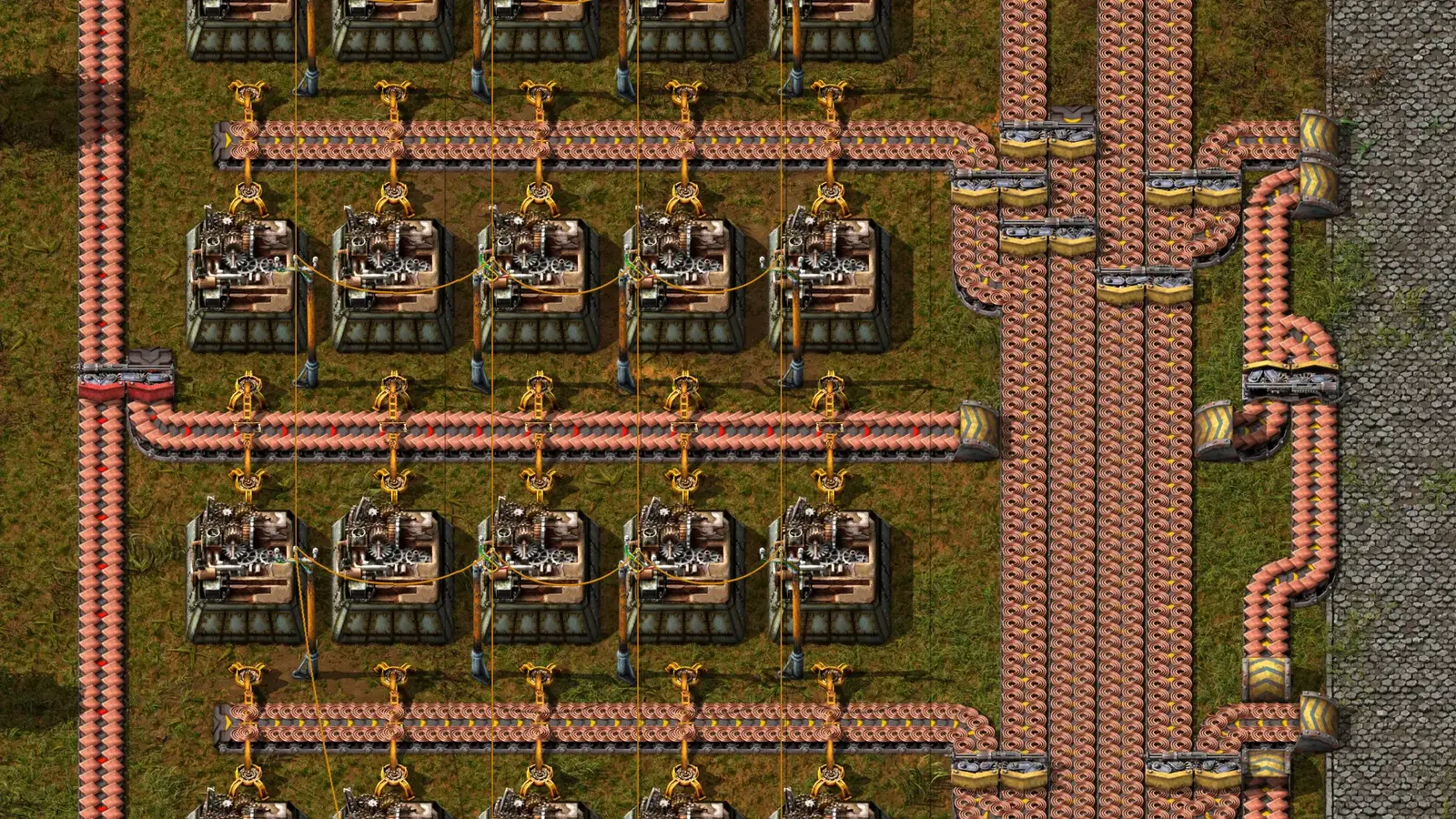 Rows of automated assembling machines connected by conveyor belts in the video game Factorio