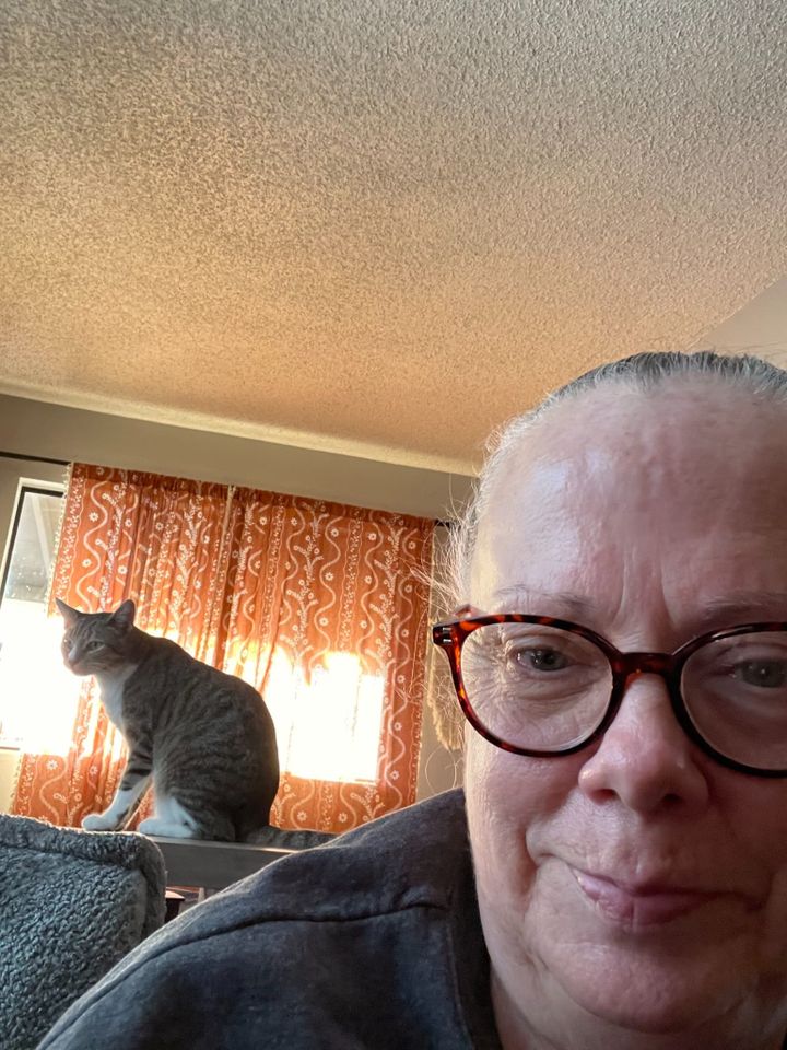 MEMAW wearing her new readers with Charlie sitting behind her in the sunlight.