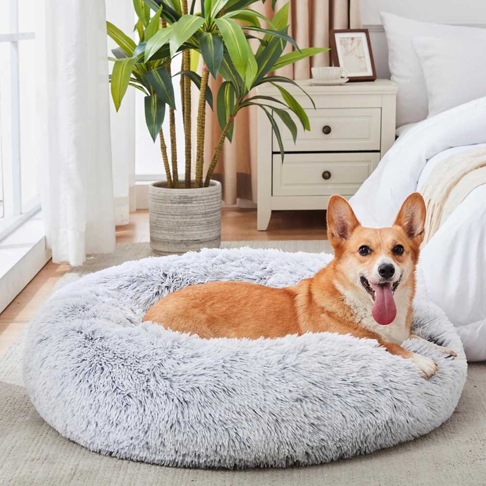 Soft, faux fur donut dog bed with raised rim for comfort and security — anti-anxiety round bed in multiple sizes