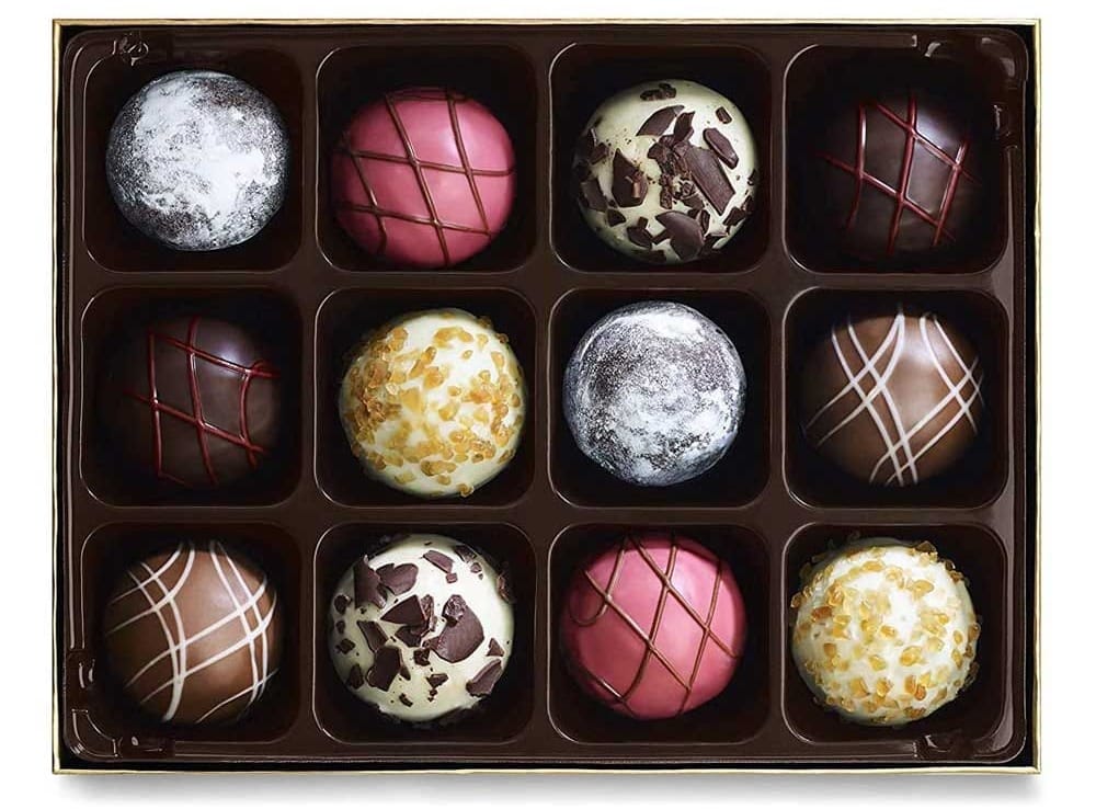 Elegant red-ribboned Godiva gift box with assorted gourmet chocolates — romantic and indulgent treat for girlfriends with a sweet tooth