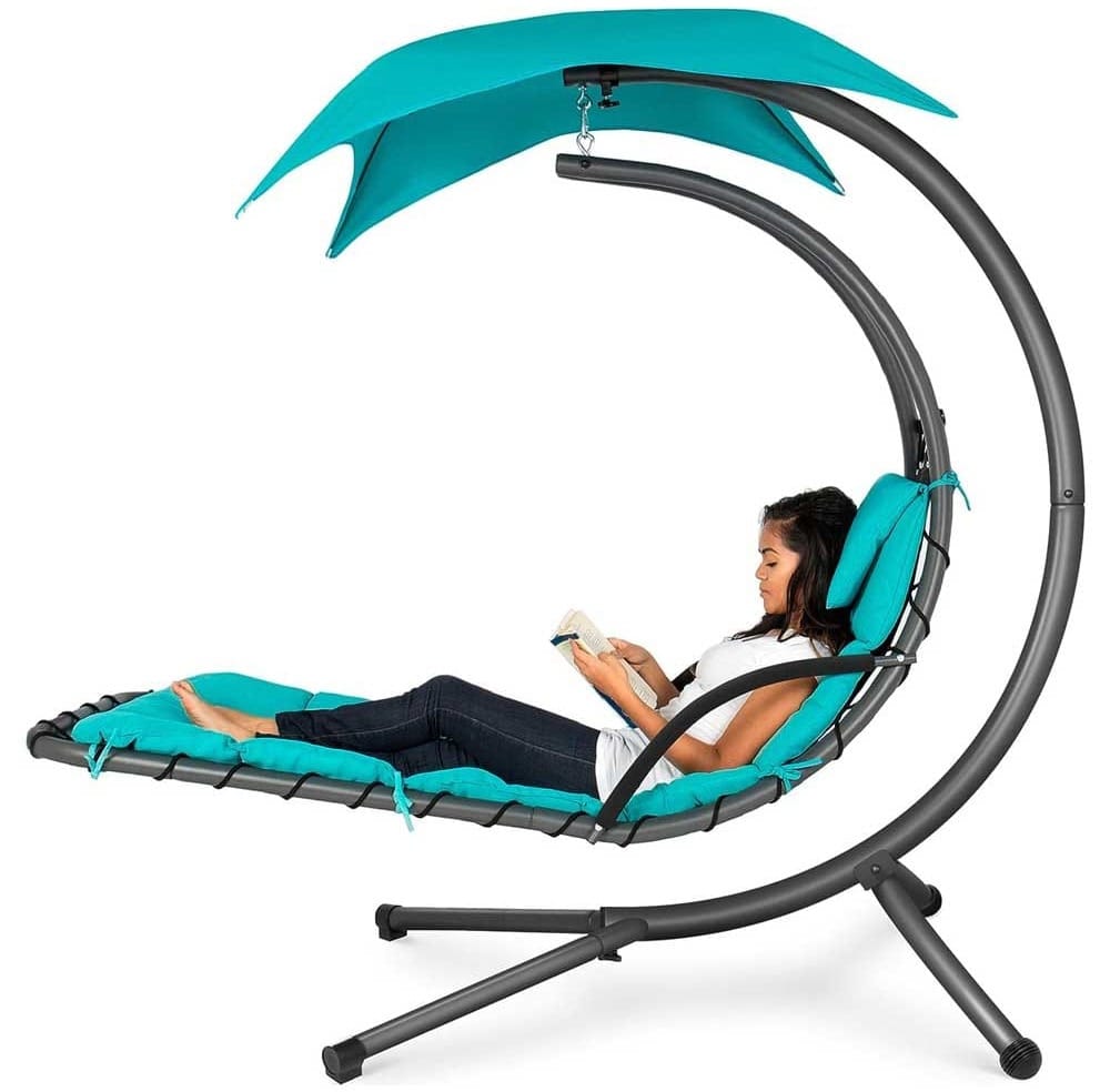 Outdoor curved steel hanging lounger with canopy and padded cushion — luxurious housewarming gift for backyard relaxation