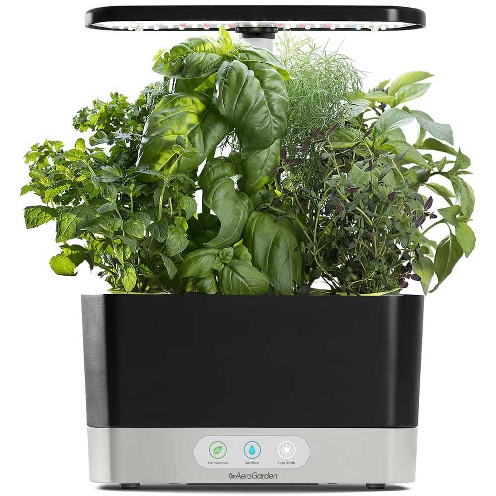 Compact hydroponic indoor garden with LED grow light and herb pods — ideal gift for couples to grow fresh herbs and greens at home