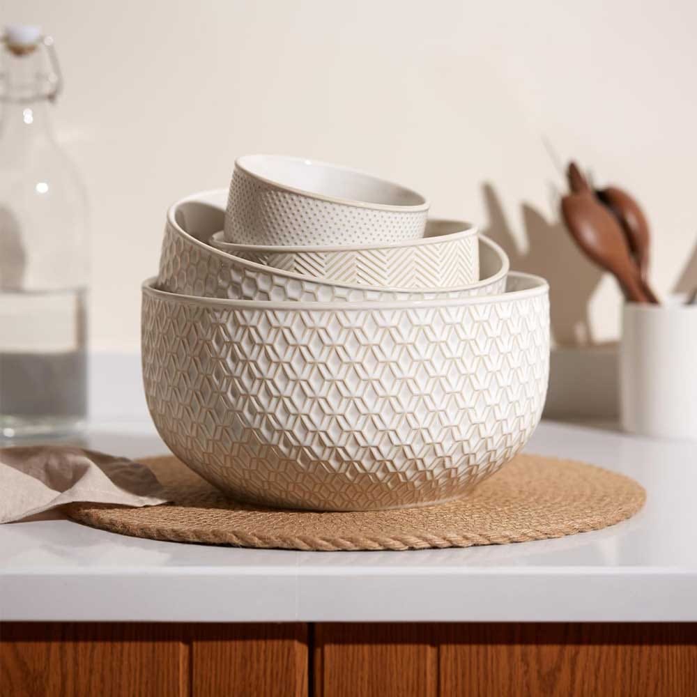 Set of ceramic nesting bowls in cream stoneware with copper accents — versatile, stackable kitchen gift for new homes