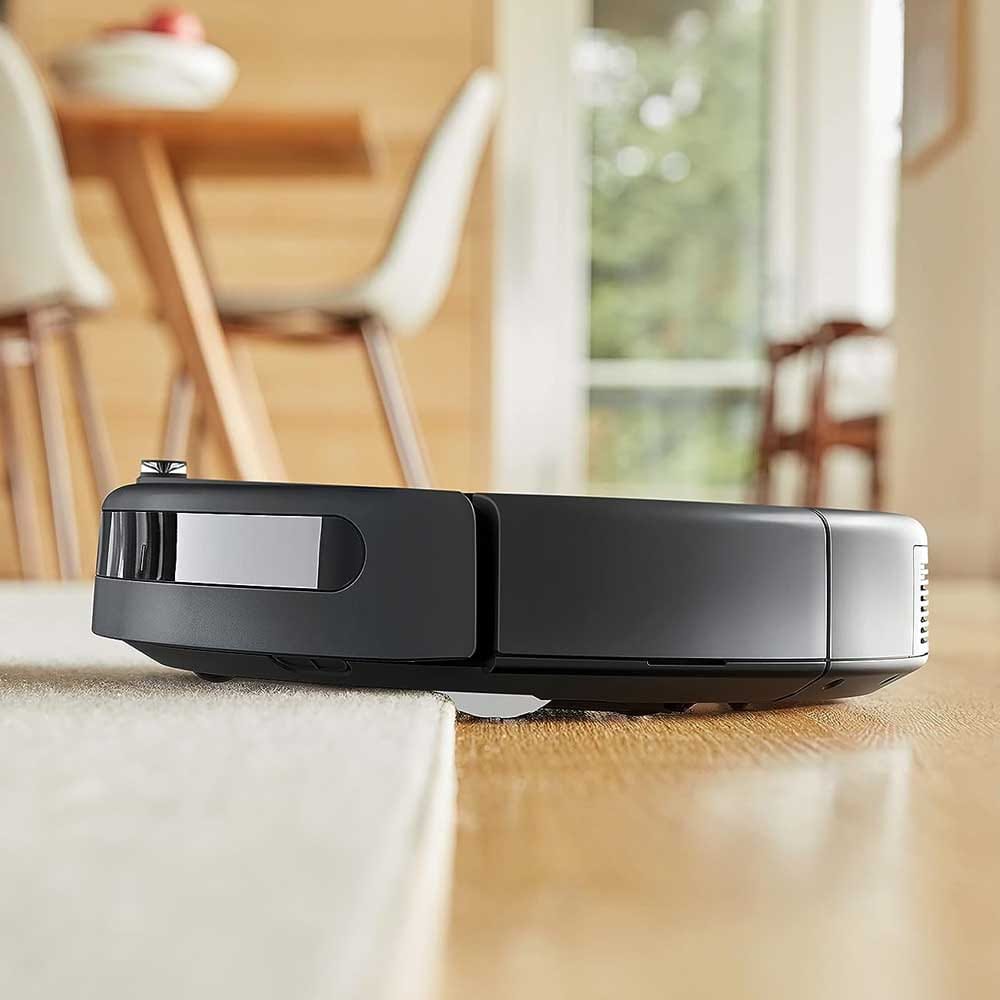Roomba robot vacuum gliding across a hardwood floor — a thoughtful, hands-free gift for Grandpa that keeps his home tidy with zero effort