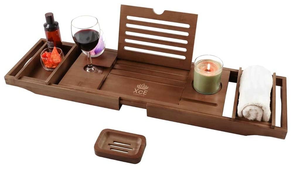 Expandable bamboo bathtub tray with wine glass holder and book slot — relaxing gift for moms who love a soak