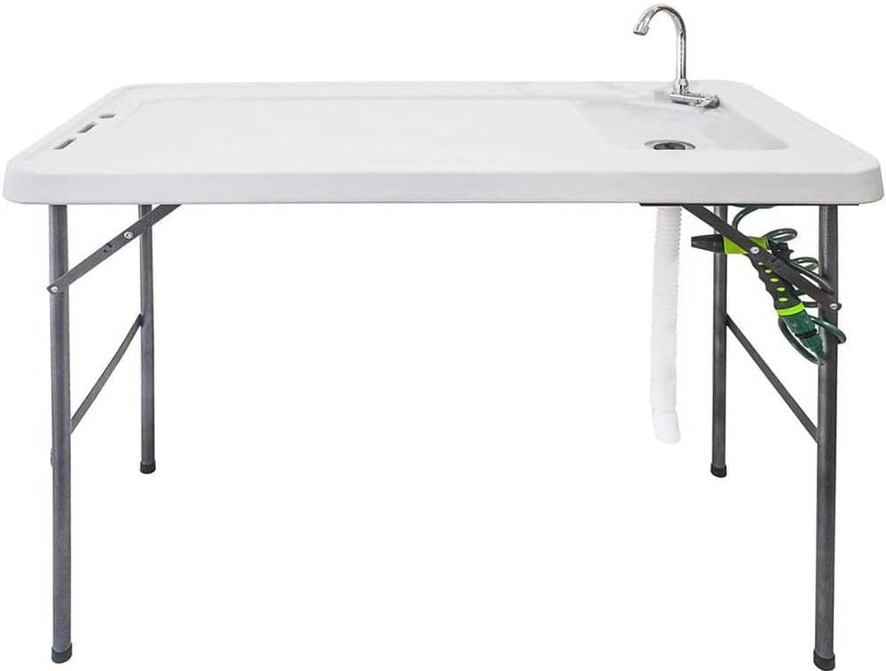Folding fish cleaning table with HDPE surface, built-in sink, spray nozzle, and faucet — portable and sturdy for prepping and cleaning fresh catch outdoors