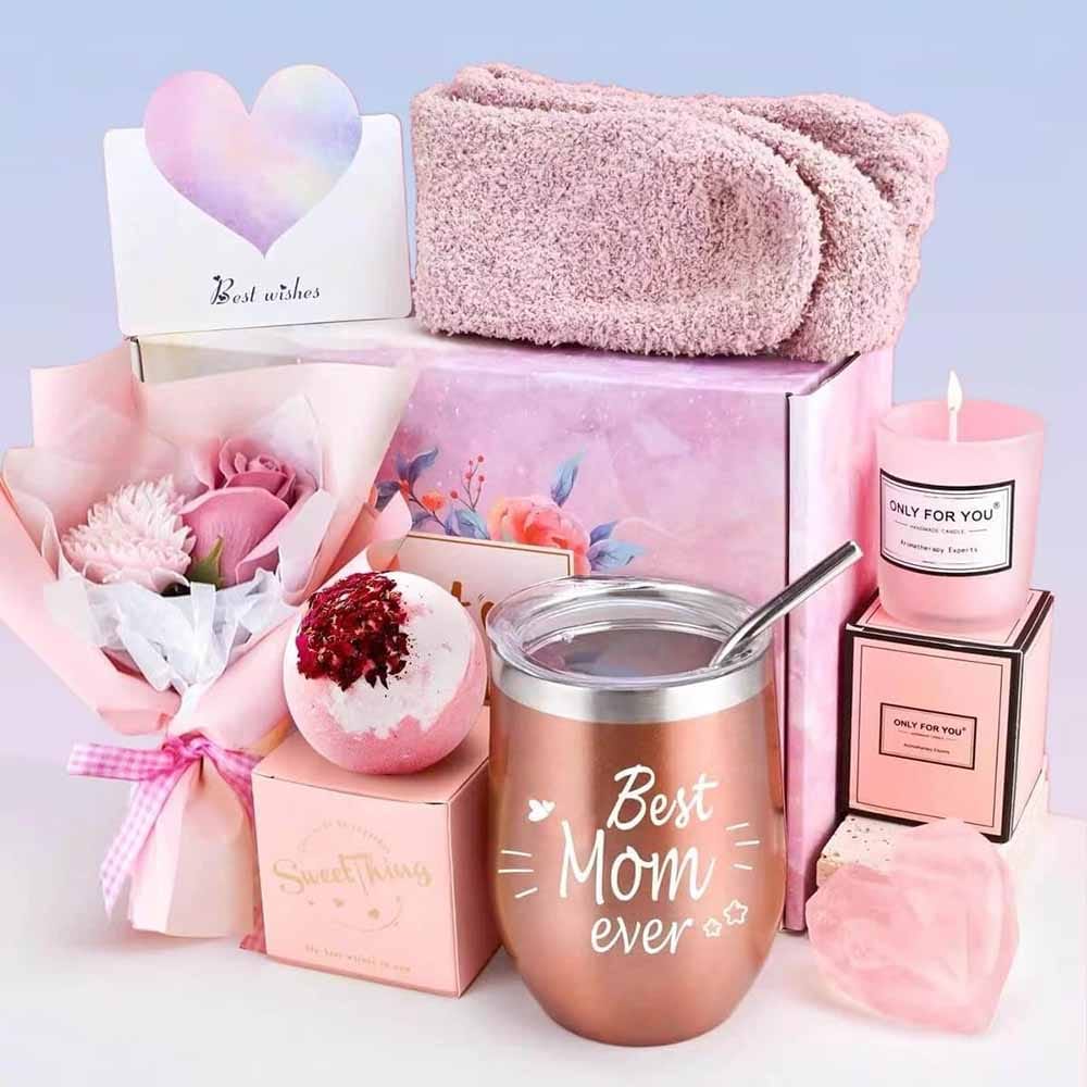 Spa gift basket with heart-shaped soap, bath bomb, candle, plush socks, tumbler, and flowers — a relaxing self-care gift for new moms