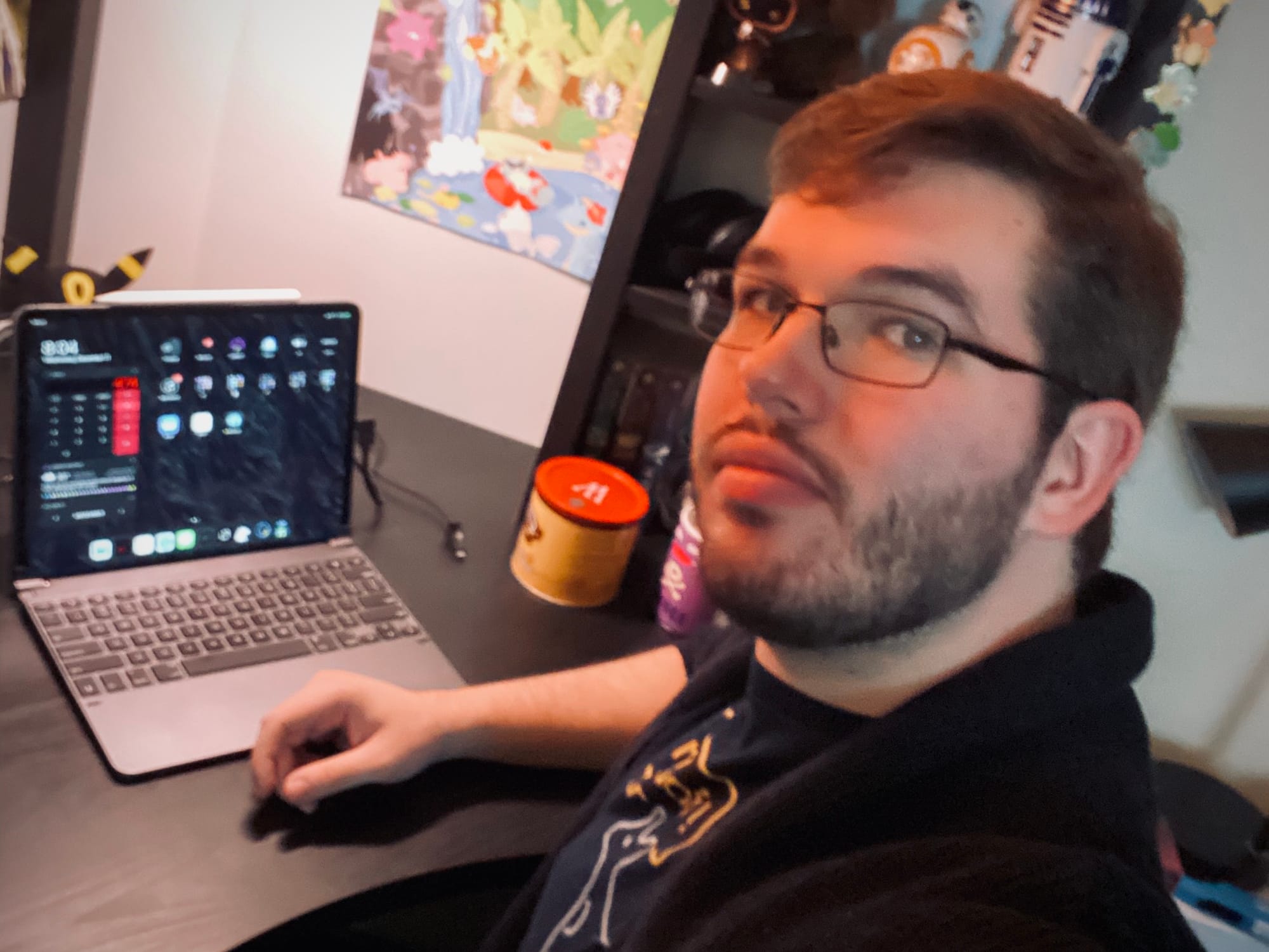 Wesley Hilliard with a short beard and short hair at a black desk with an iPad Pro sitting in a Brydge keyboard