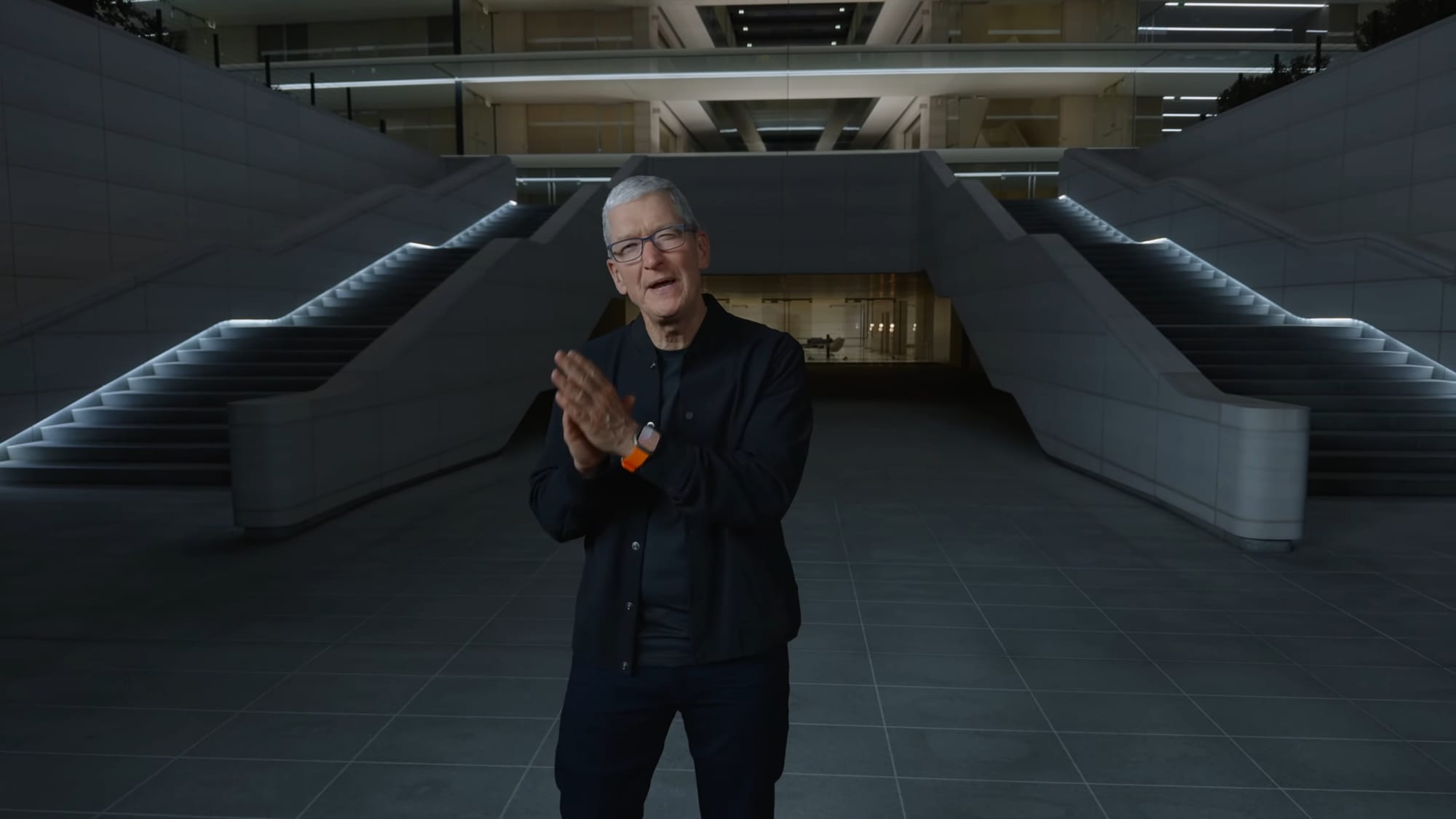 Tim Cook speaks in front of stairs at Apple Park during a keynote address