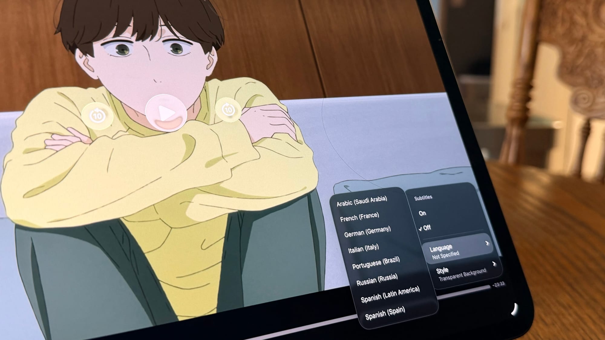 A photo of an iPad playing the anime 'Journal With Witch' with the subtitle options open
