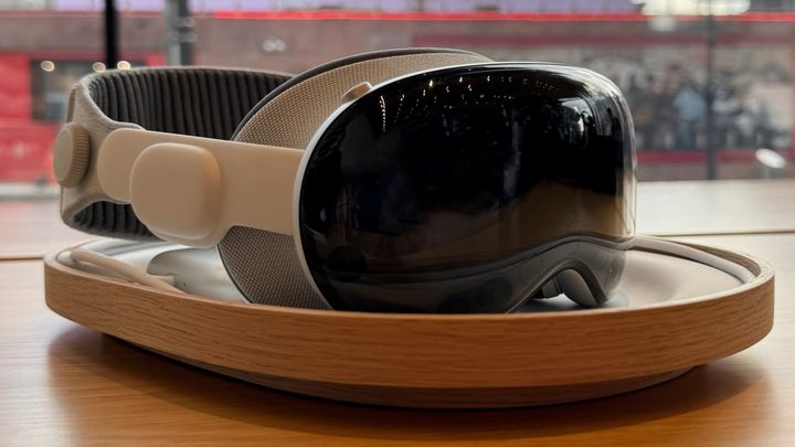 Apple Vision Pro on a wood stand on display in an Apple Store with a glass wall behind it showing Nashville