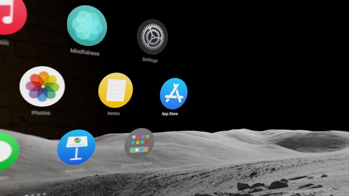 A screenshot of the visionOS Home View with round icons floating in an immersive environment of the moon
