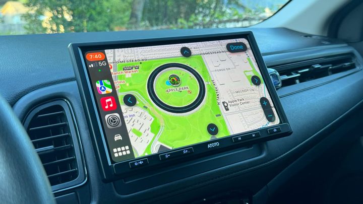 An aftermarket 10-inch display in a vehicle showing the CarPlay interface opened to Apple Park