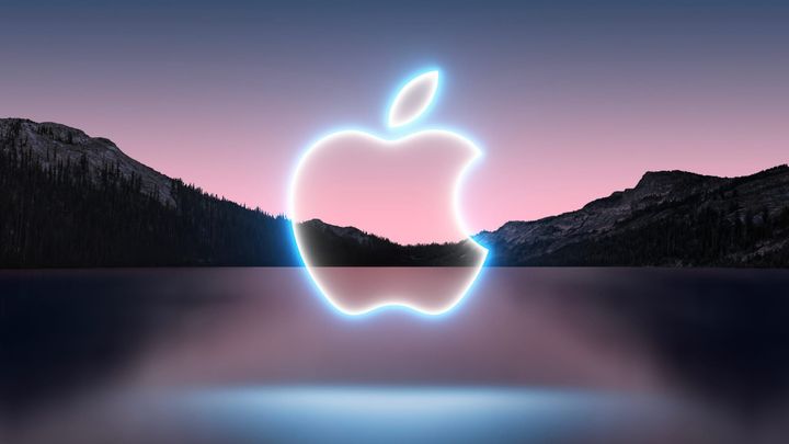 A neon Apple logo over a lake in California with mountains in the background