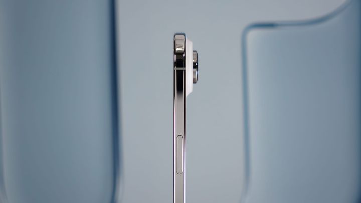 The iPhone Air seen from the side with the camera plateau and lens visibly protruding from the side.