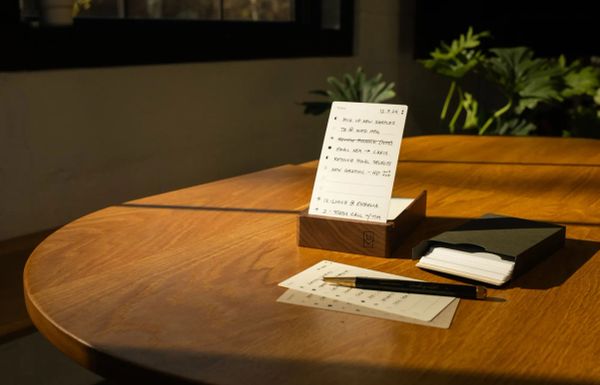 Ugmonk's Analog card system on a sunlit table with a plant in the background