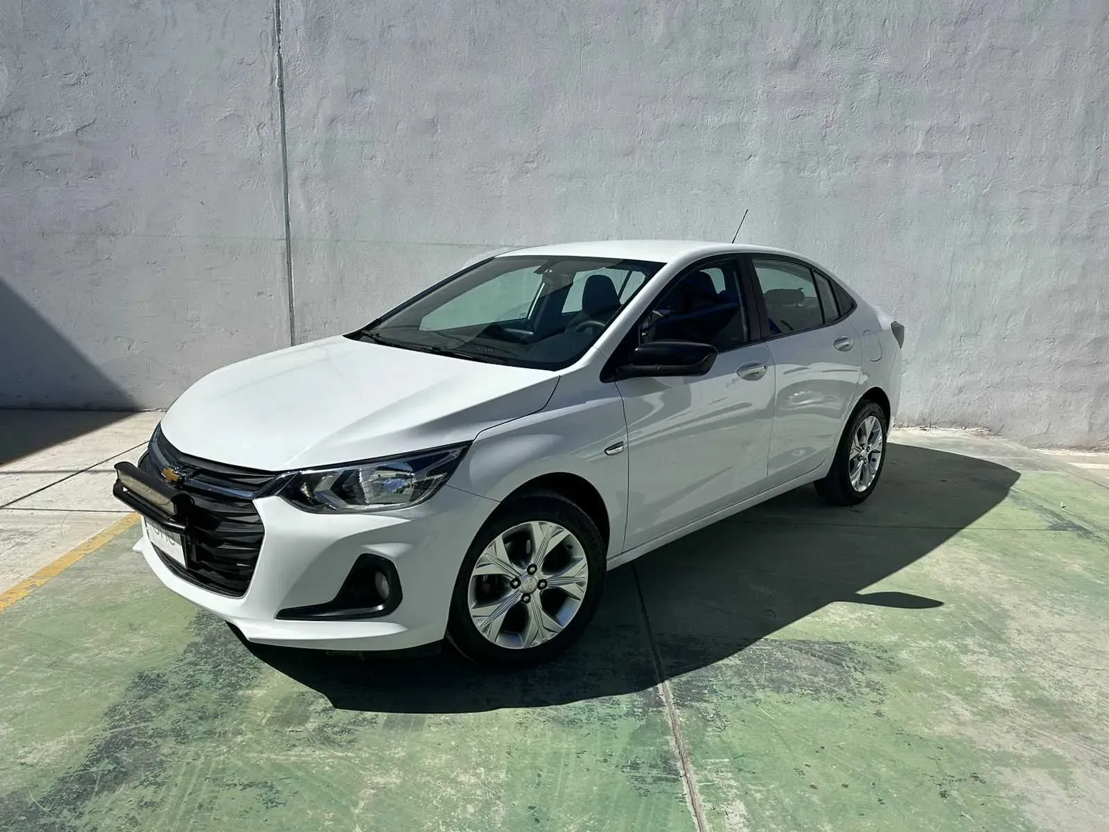 Grúa cargando un auto usado en un lote